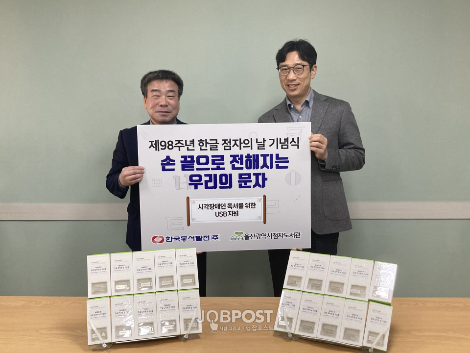 30일 오후 2시 '제98주년 한글 점자의 날'을 기념해 마련된 시각장애인 독서를 위한 USB 지원식에서 박창수 동서발전 사회공헌부장(왼쪽)과 이만주 울산시점자도서관장(오른쪽)이 기념촬영하고 있다.(사진_동서발전)
